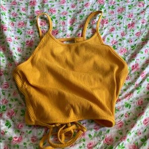 A yellow open back top